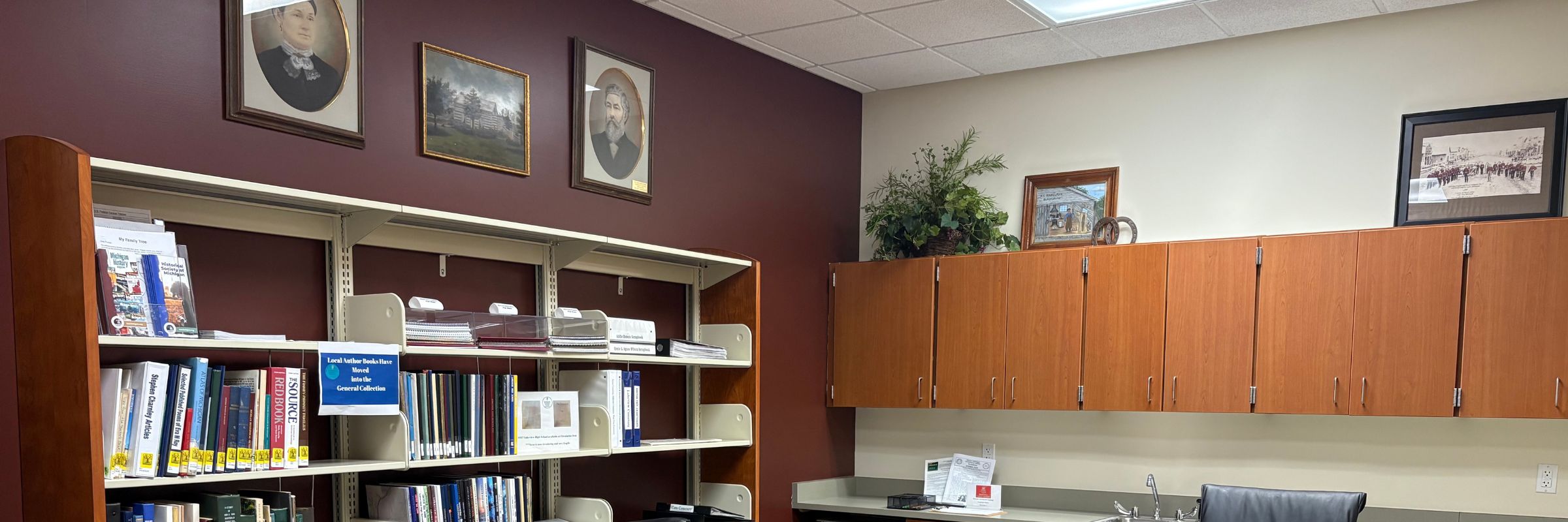 Photo of Maxwell Room with reference materials on shelves, historic photos, and cabinets along opposite wall
