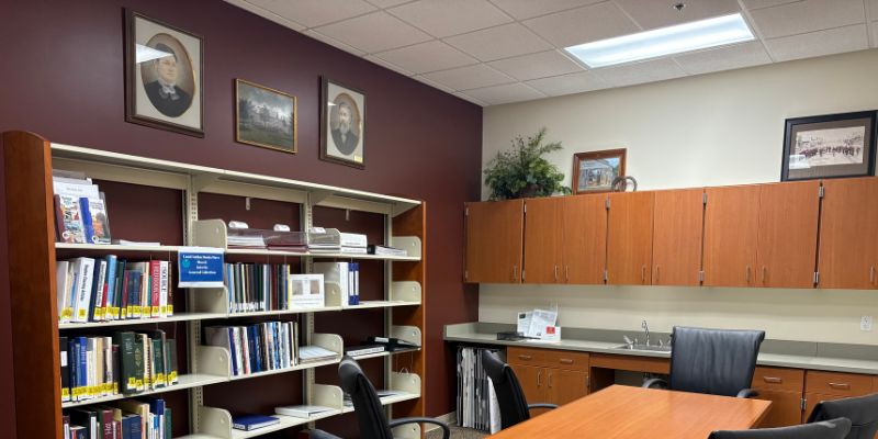 Maxwell Room collection shelves, cabinets, and historic images on walls