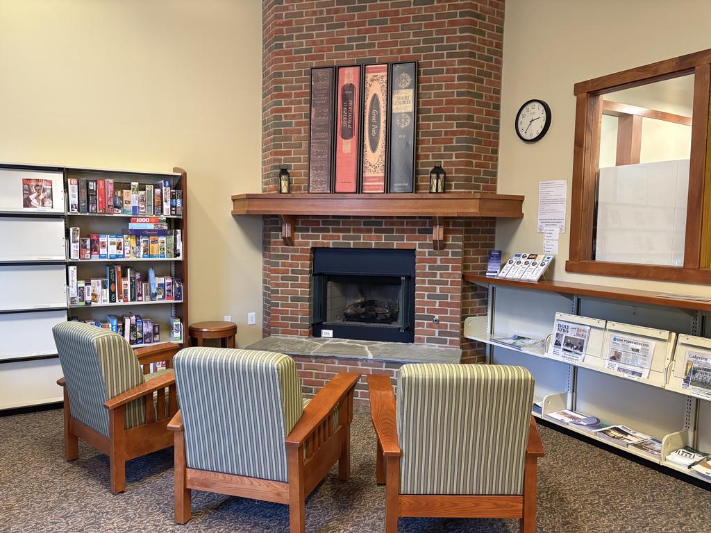Reading Room interior showing chairs, a fireplace, and books on shelves