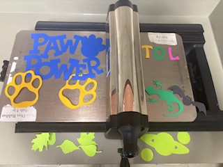 Die cut machine with various colorful cutouts