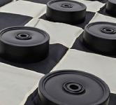 Black and white checkerboard and black checker pieces
