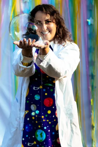 Presenter Angelina Bertoni holding a bubble in her hands