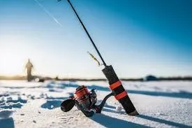 An ice fishing pole sitting on a frozen lake.