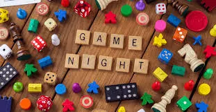 Colorful board game pieces and game night spelled out with scrabble letters.