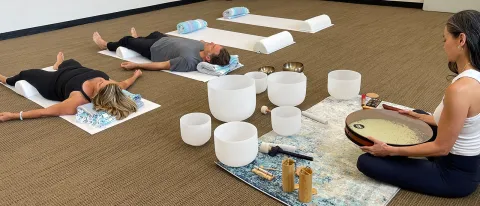 people laying on yoga baths participating in a sound bath
