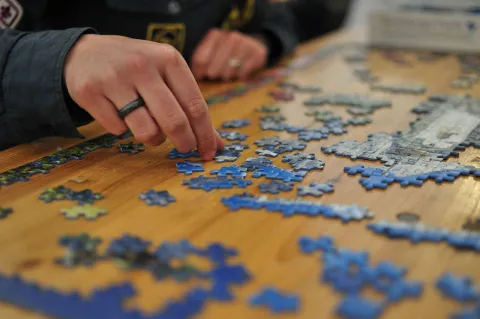 picture of someone putting together a jigsaw puzzle