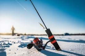 An ice fishing pole sitting on a frozen lake.